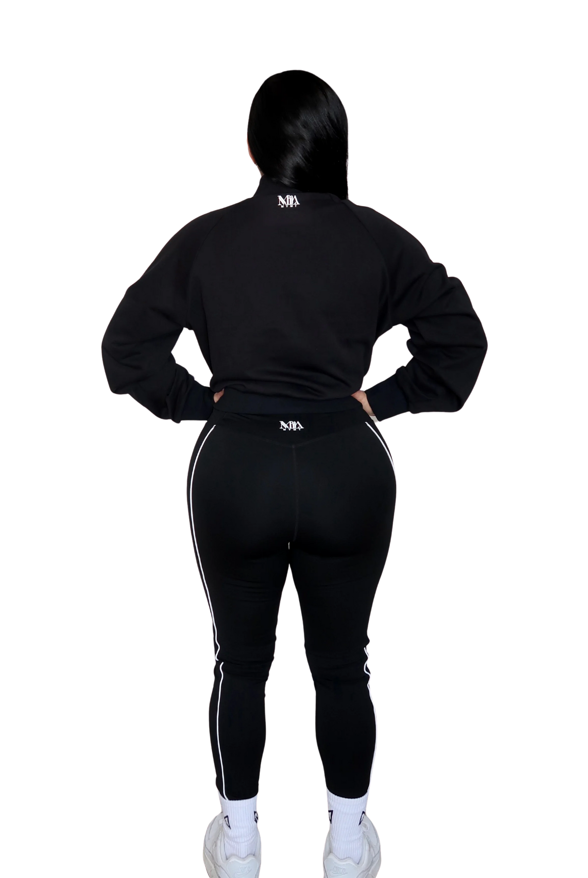 Back view of woman wearing a full black hoodie