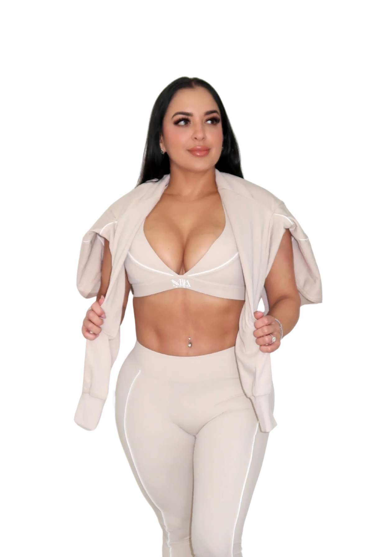 Woman wearing a beige jacket draped over shoulders