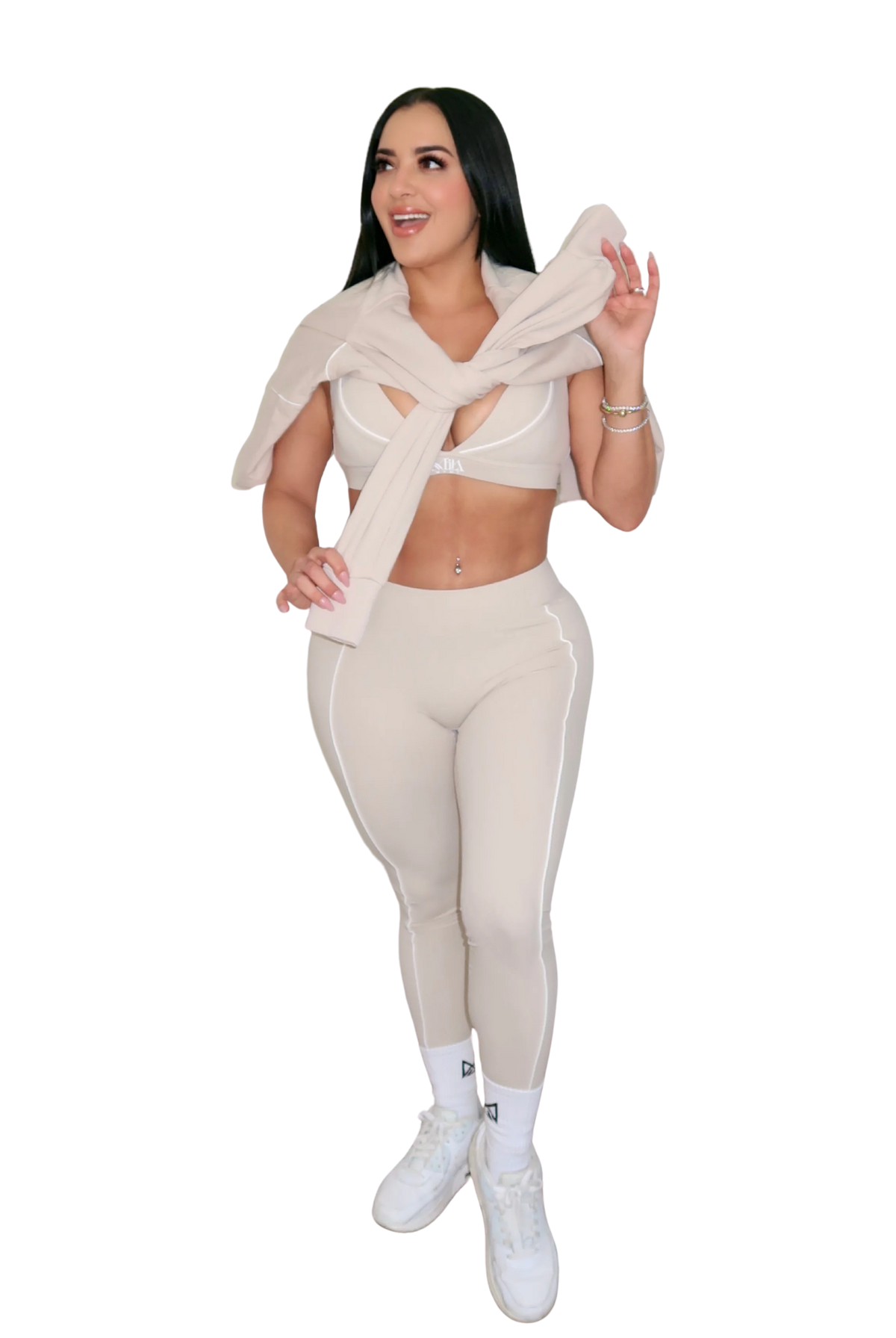 Front full body view of woman with beige jacket over shoulders