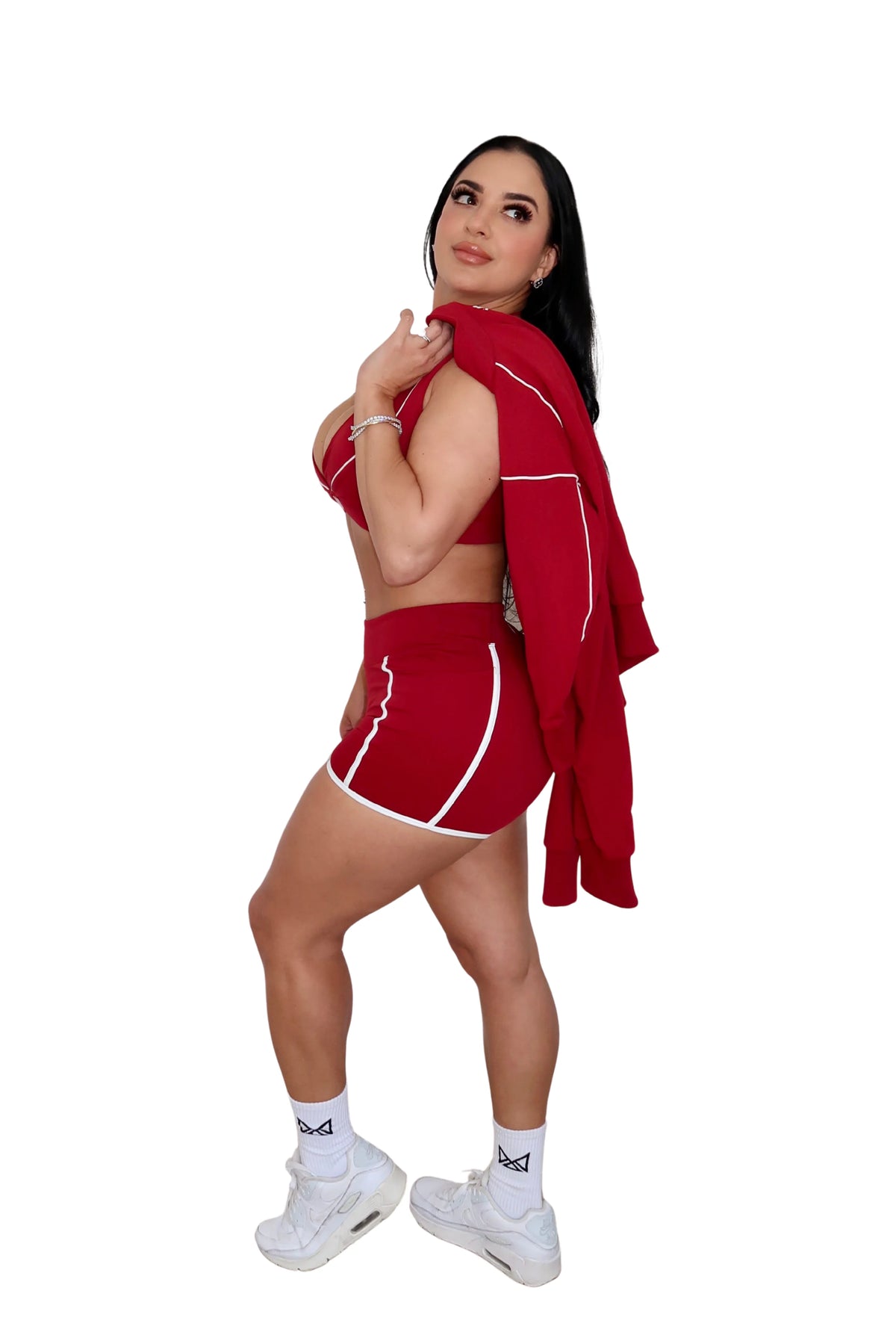 Woman in red athletic outfit with towel on white background