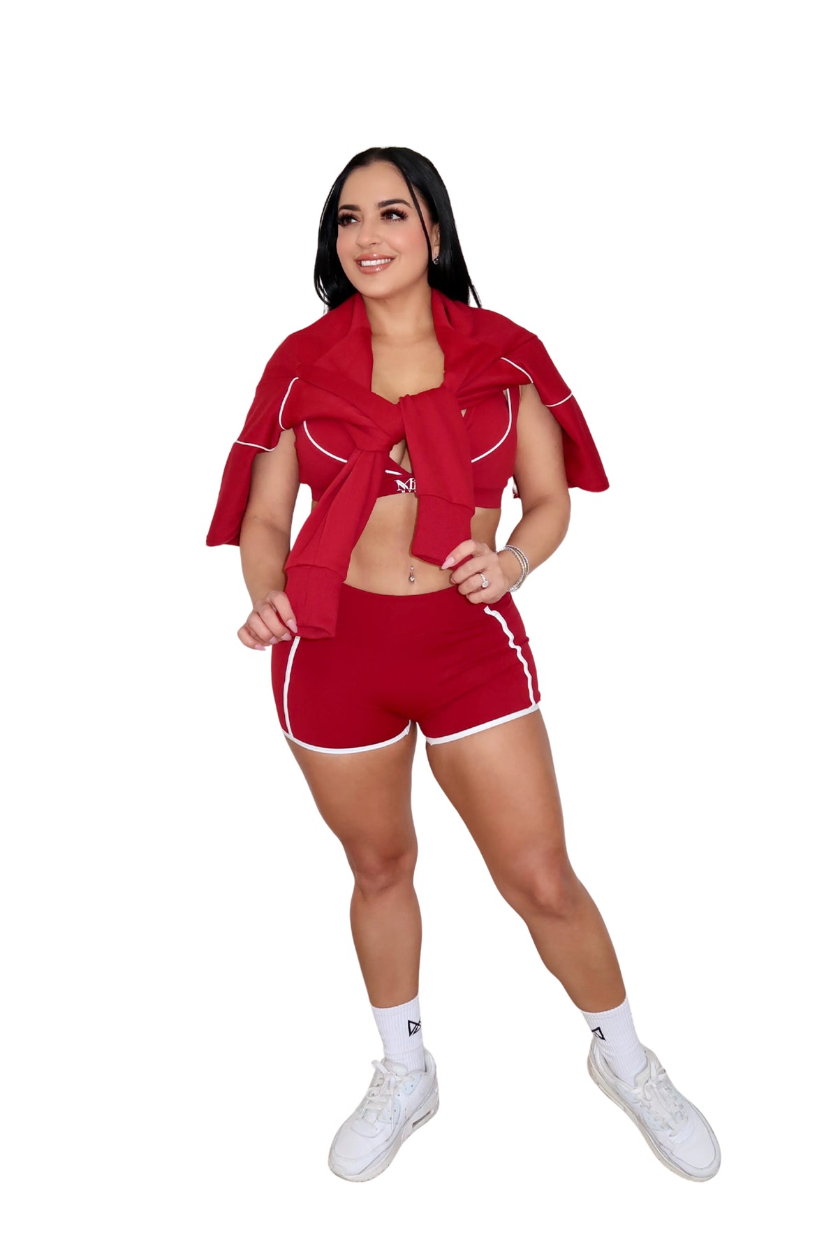 Person wearing a red athletic outfit with white accents on a white background