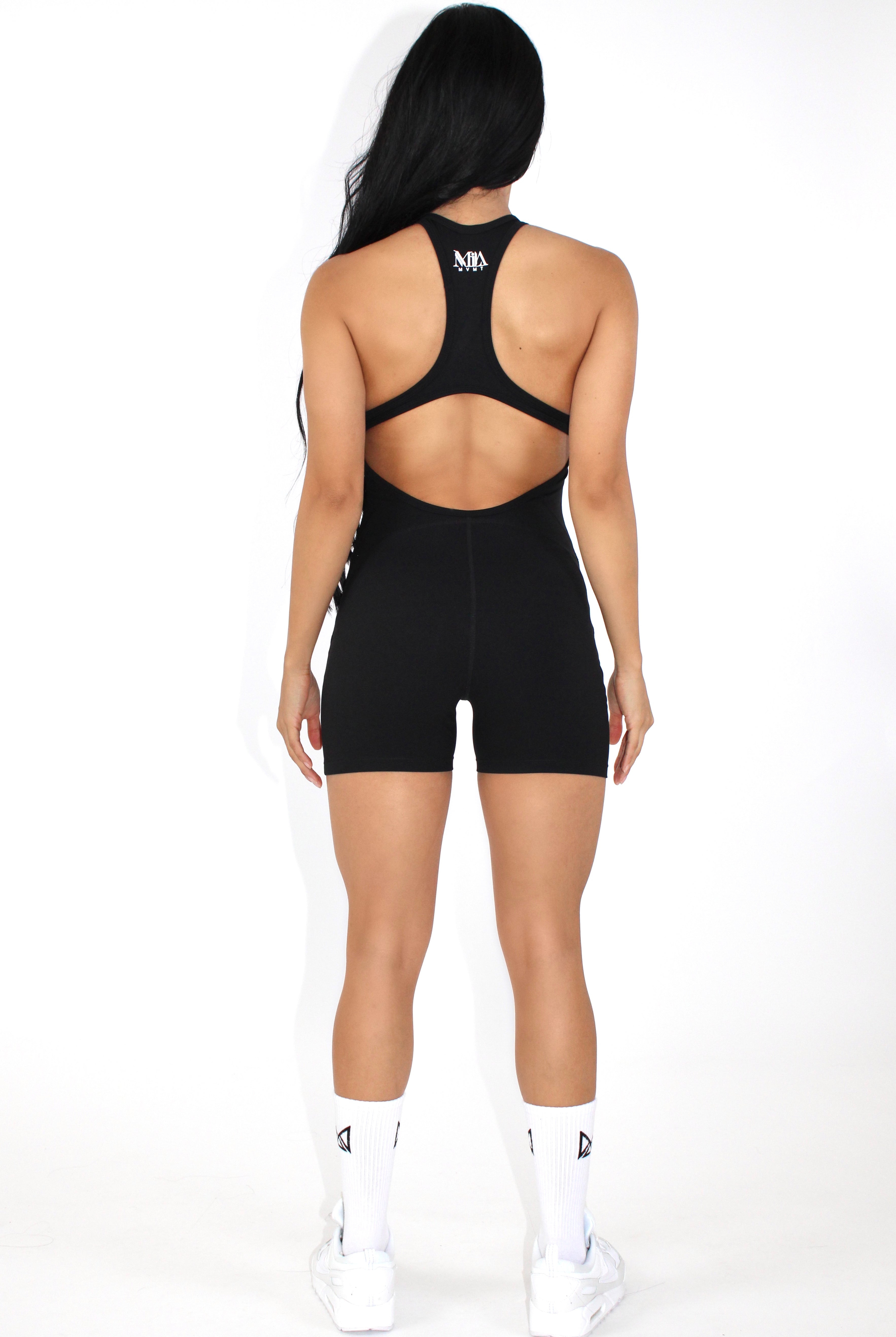 Women wearing a black MILA MVMT Sportswear One-Piece Gym Workout Romper Onesie - facing back