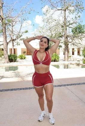 Woman wearing red sculpt activewear set with shorts and sports bra