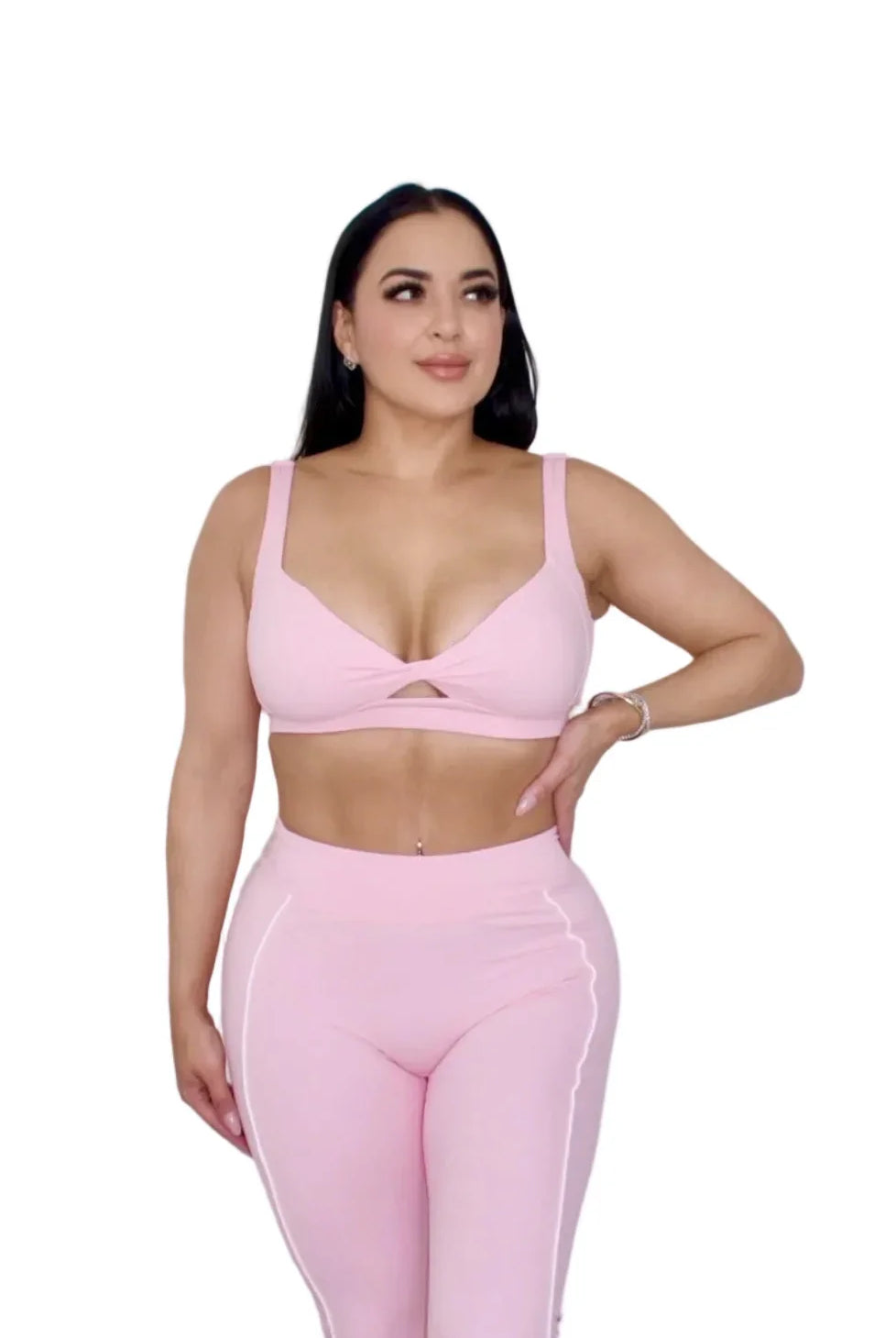 Woman wearing petal pink sports bra by MILA MVMT, medium front view