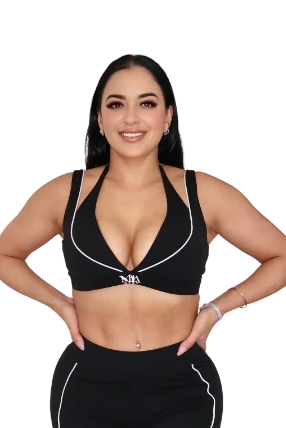 Woman wearing a black sports bra and leggings on a white background
