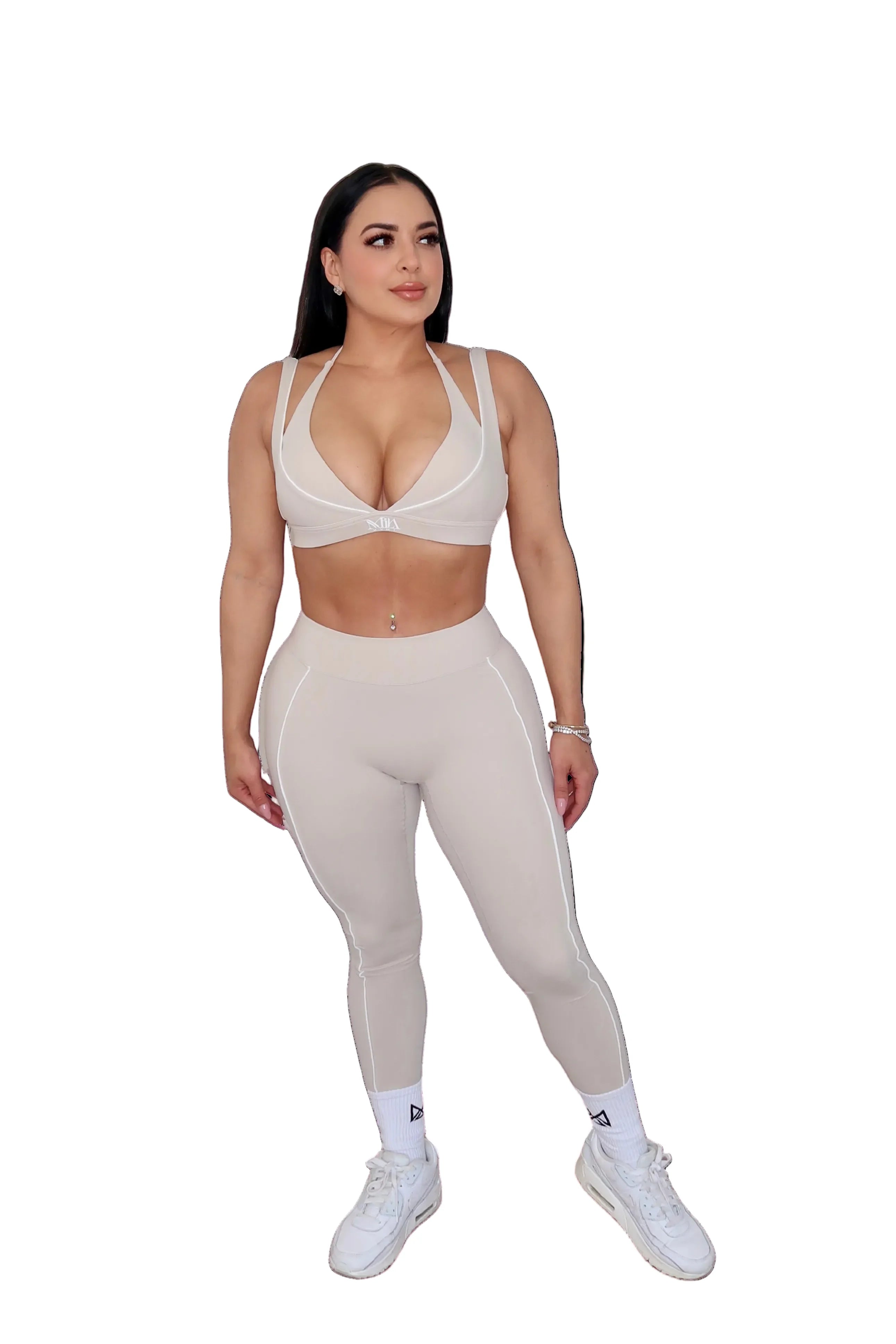 Woman wearing a beige outfit on a white background