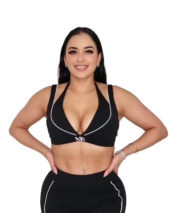 Woman wearing a black sports bra and leggings on a white background