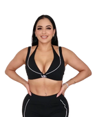 Woman wearing a black sports bra and leggings on a white background