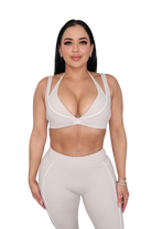 Woman in a beige athletic outfit 