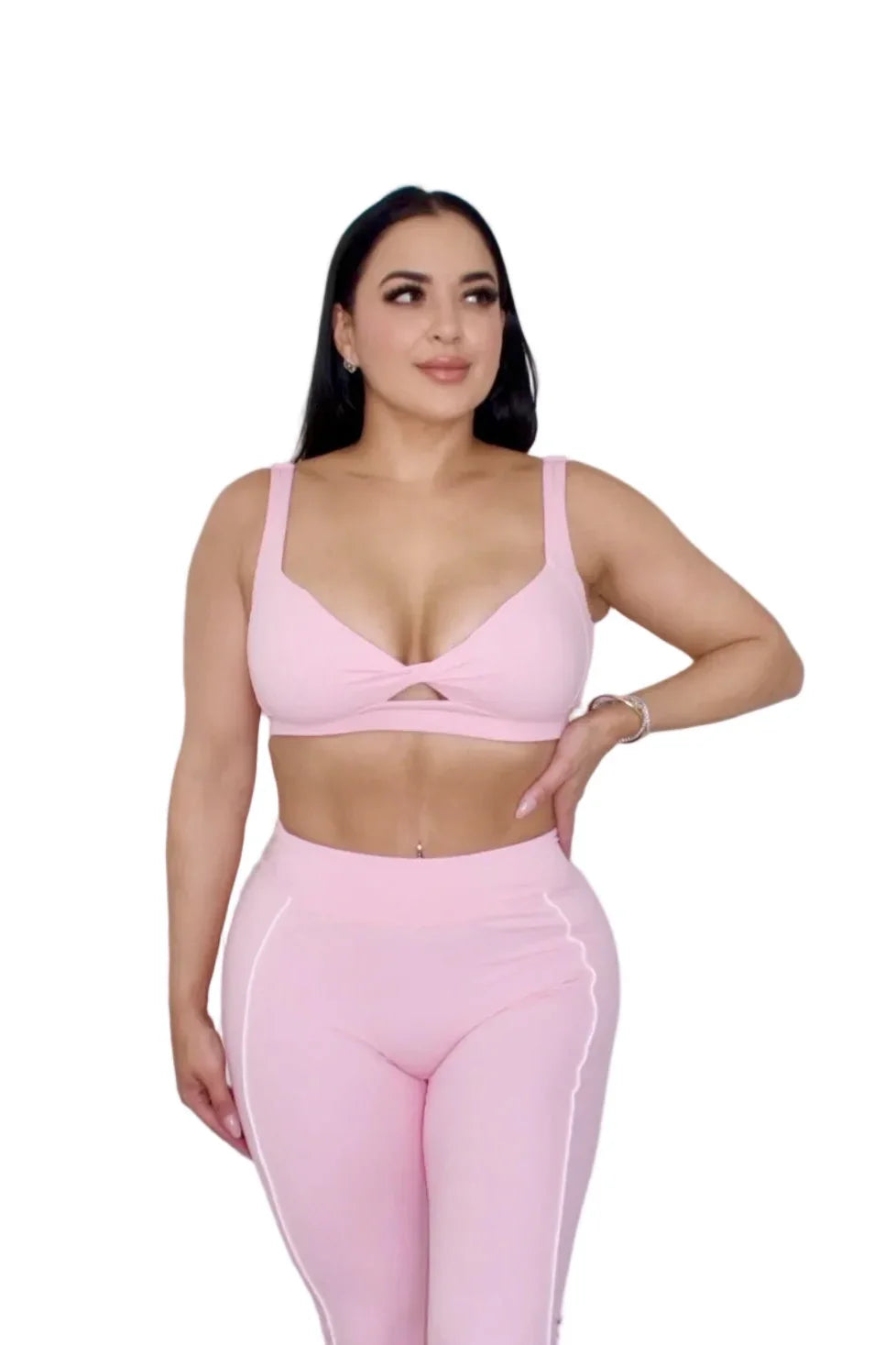 Woman wearing petal pink sports bra by MILA MVMT, medium front view