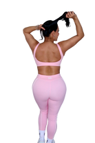Back view of woman wearing petal pink sports bra by MILA MVMT, full body