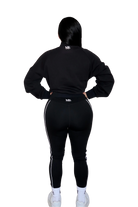 Back view of woman wearing a full black hoodie