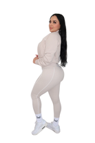 Side view of woman wearing a beige jacket, full body