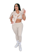 Front full body view of woman with beige jacket over shoulders