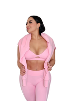 Woman in petal pink jacket by MILA MVMT, medium front view