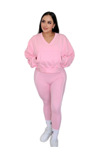 Full body front view of woman wearing petal pink jacket by MILA MVMT