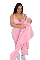 Woman holding petal pink jacket by MILA MVMT, full body front view