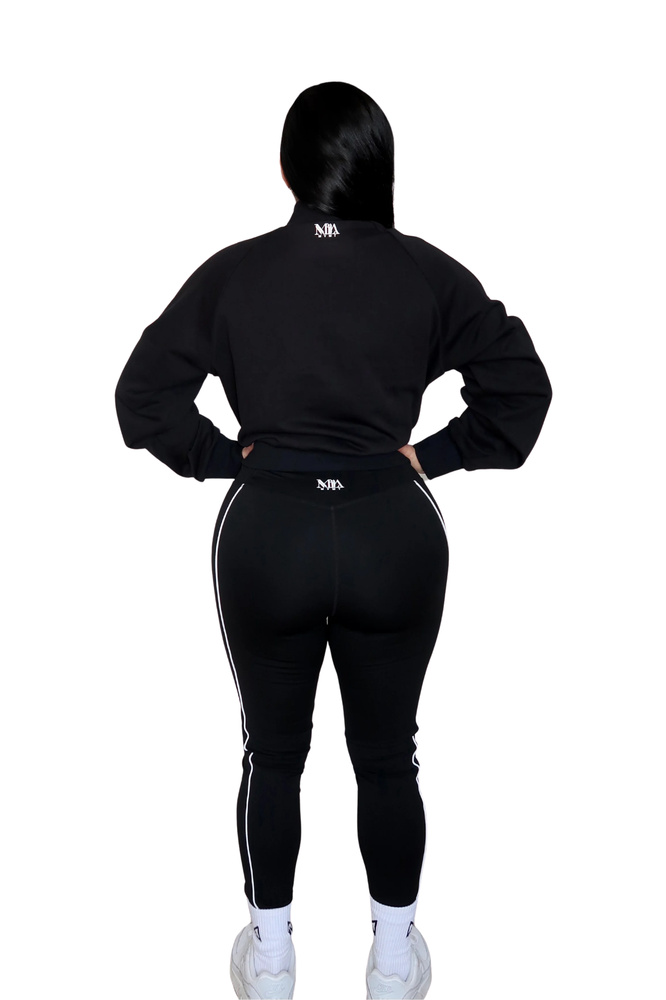 Back view of woman wearing a full black hoodie