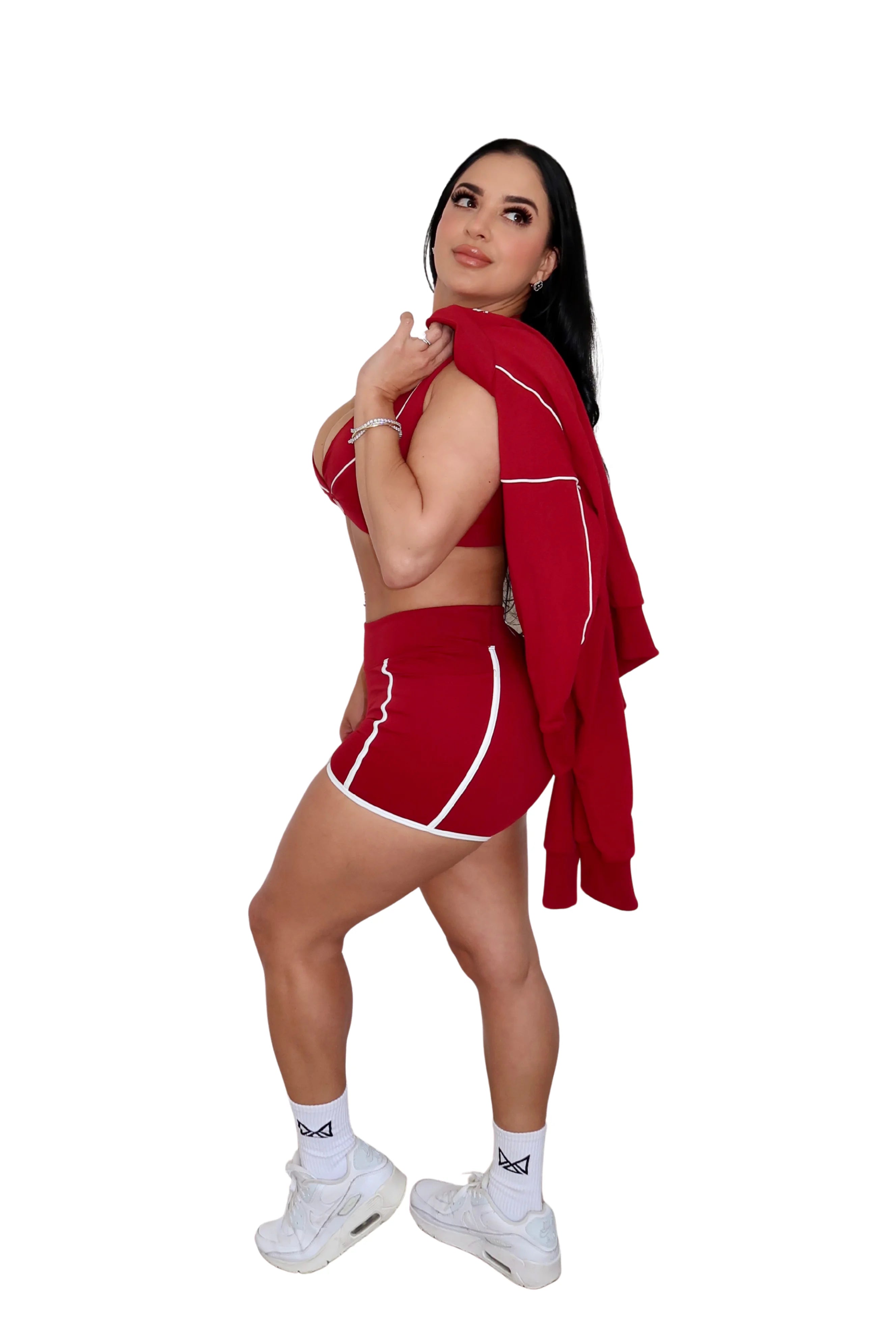 Woman in red athletic outfit with towel on white background