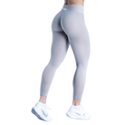 Gray leggings worn by a person on a white background