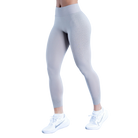 Gray leggings worn by a person on a white background
