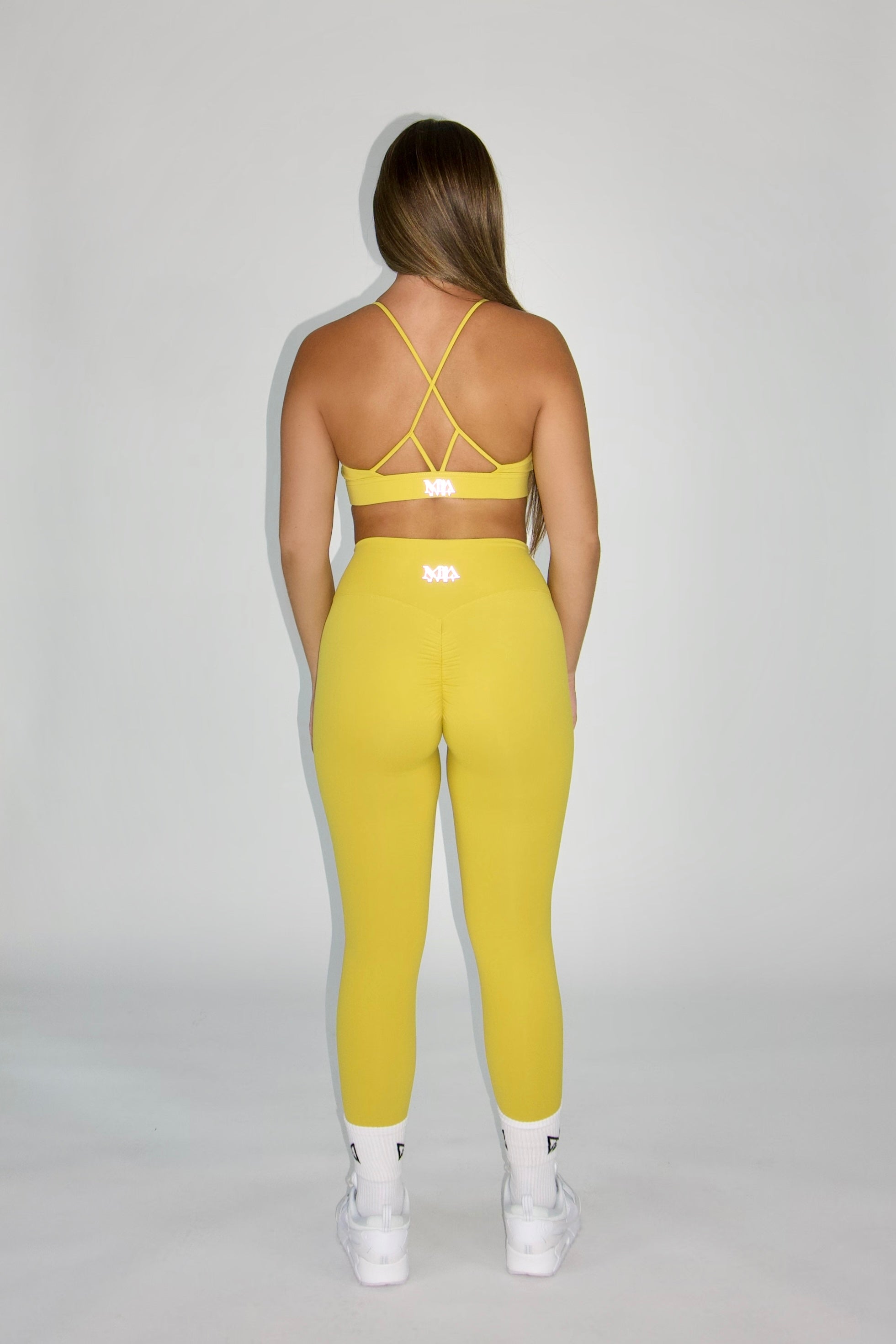 MILA MVMT Sportswear Emmie Sports Bra & Emmie Leggings Mustard Yellow - back view