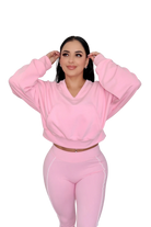 Woman in petal pink hoodie by MILA MVMT, medium front view