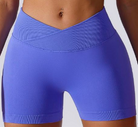 Blue athletic shorts worn by a person on a white background