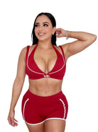Woman wearing red activewear set for pilates and gym workout