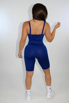 woman wearing navy blue sports corset romper from mila mvmt sportswear